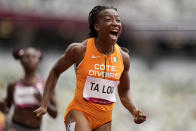 Marie-Josee Ta Lou, of the Ivory Coast, wins a heat in the women's 100-meter run at the 2020 Summer Olympics, Friday, July 30, 2021, in Tokyo. (AP Photo/Martin Meissner)