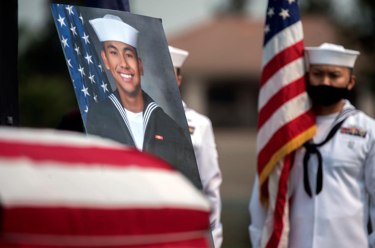 A large photo of Christopher "Bobby" Gnem was place next to his casket as a color guard from the Navy Operations Naval Reserve unit from Sacramento hold flags during funeral services Aug. 23 at the home of Joe Fasso in Stockton. Gnem a Stockton native, was killed in an accident during a Marine training mission in Southern California while serving as a Navy corpsman with the 5th Marine Expeditionary Unit in July.