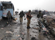Indian soldiers examine the debris after an explosion in Lethpora in south Kashmir's Pulwama district February 14, 2019. REUTERS/Younis Khaliq