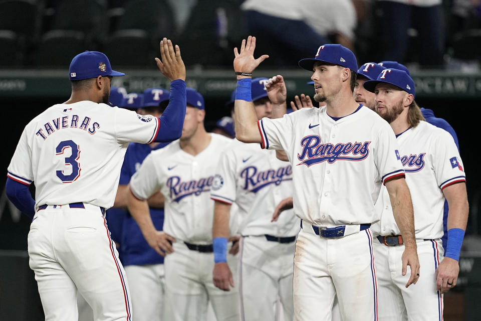 Texas Rangers' Leody Taveras (3) and Evan Carter, front right, celebrate with teammates after the team's win in a baseball game against the Washington Nationals in Arlington, Texas, Tuesday, April 30, 2024. (AP Photo/Tony Gutierrez)