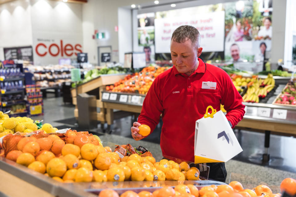Coles worker packing produce