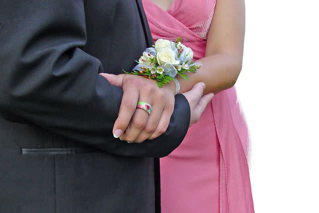 <p>Getty</p> A couple holding hands at prom (stock image)