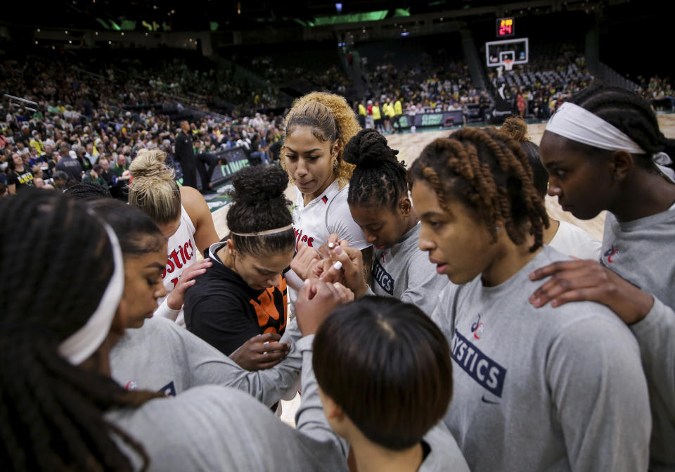 The Washington Mystics huddle before Game 1 of the team's WNBA basketball first-round playoff series against the Seattle Storm on Thursday, Aug. 18, 2022, in Seattle. (AP Photo/Lindsey Wasson)