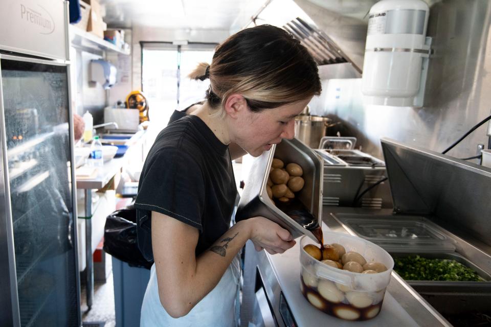 Miki Nolin, owner of Ramen Bones, prepares shoyu eggs.