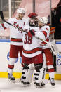 Carolina Hurricanes center Vincent Trocheck (16) and defenseman Jaccob Slavin (74) celebrate with goaltender Alex Nedeljkovic (39) after the Hurricanes defeated the Florida Panthers 3-2 in an overtime period of an NHL hockey game, Monday, March 1, 2021, in Sunrise, Fla. (AP Photo/Wilfredo Lee)