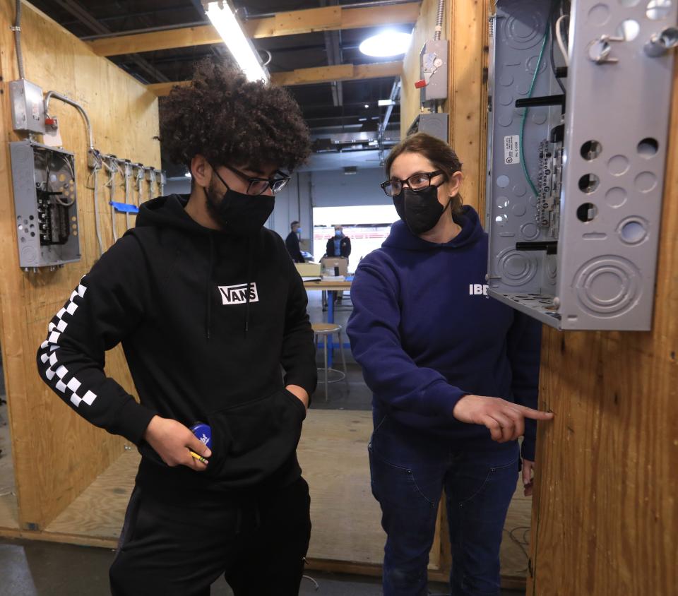 Julian Reyes gets input from Candace Eustace, the class' union electrician/instructor at Hudson Valley Community College in Troy on February 22, 2022. Reyes is a student in the college's Electrical Construction and Maintenance program. 