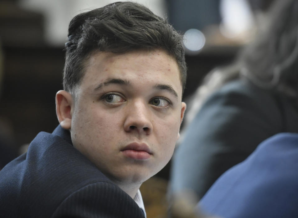 Kyle Rittenhouse looks back as Susan Hughes, the great aunt of Anthony Huber, enters the courtroom during his trial at the Kenosha County Courthouse in Kenosha, Wis., on Friday, Nov. 5, 2021. Anthony Huber was one of two men who Rittenhouse killed on Aug. 25, 2020. (Sean Krajacic/The Kenosha News via AP, Pool)