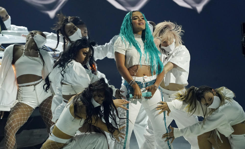Karol G performs with backup dancers at the Billboard Music Awards, Friday, May 21, 2021, at the Microsoft Theater in Los Angeles. The awards show airs on May 23 with both live and prerecorded segments. (AP Photo/Chris Pizzello)