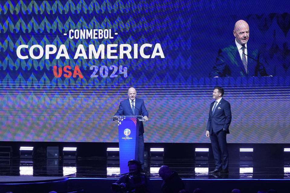 FIFA President Gianni Infantino, left, talks beside CONMEBOL President Alejandro Dominguez, during the draw for the Copa America soccer tournament, Thursday, Dec. 7, 2023, in Miami. The 16-nation tournament will be played in 14 U.S. cities starting with Argentina's opener in Atlanta on June 20, 2024. (AP Photo/Lynne Sladky)