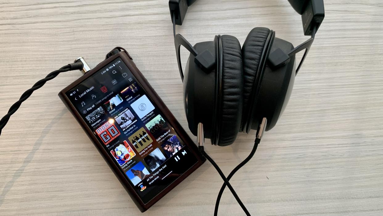  FiiO M15S with Beyerdynamic headphones, on a coffee table 