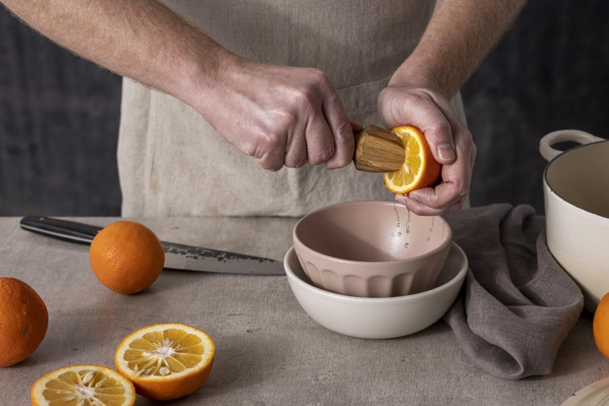 LOS ANGELES, CALIFORNIA, Jan. 19, 2022: Step-by-step citrus marmalade-cooking guide: juicing Seville oranges