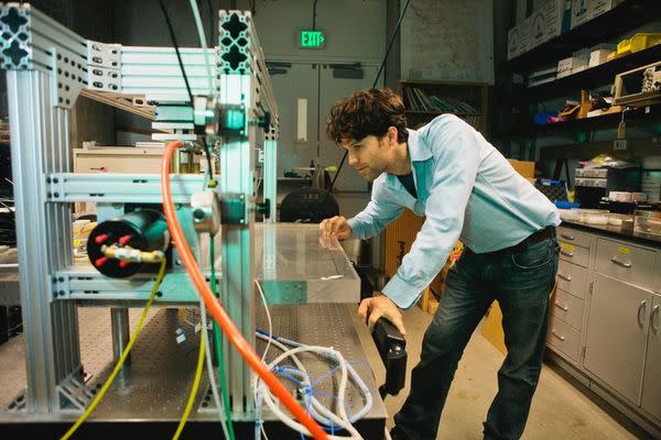 Gregory McLaskey examines a tabletop model of a fault at UC Berkeley.