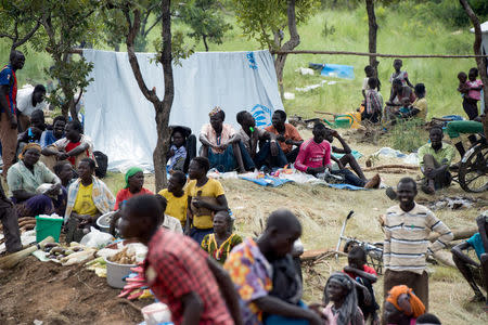 Newly arrived refugees sit outside their makeshift shelter in Amugo refugee settlement camp in Arua District, northern Uganda August 15, 2017. REUTERS/Jason Patinkin