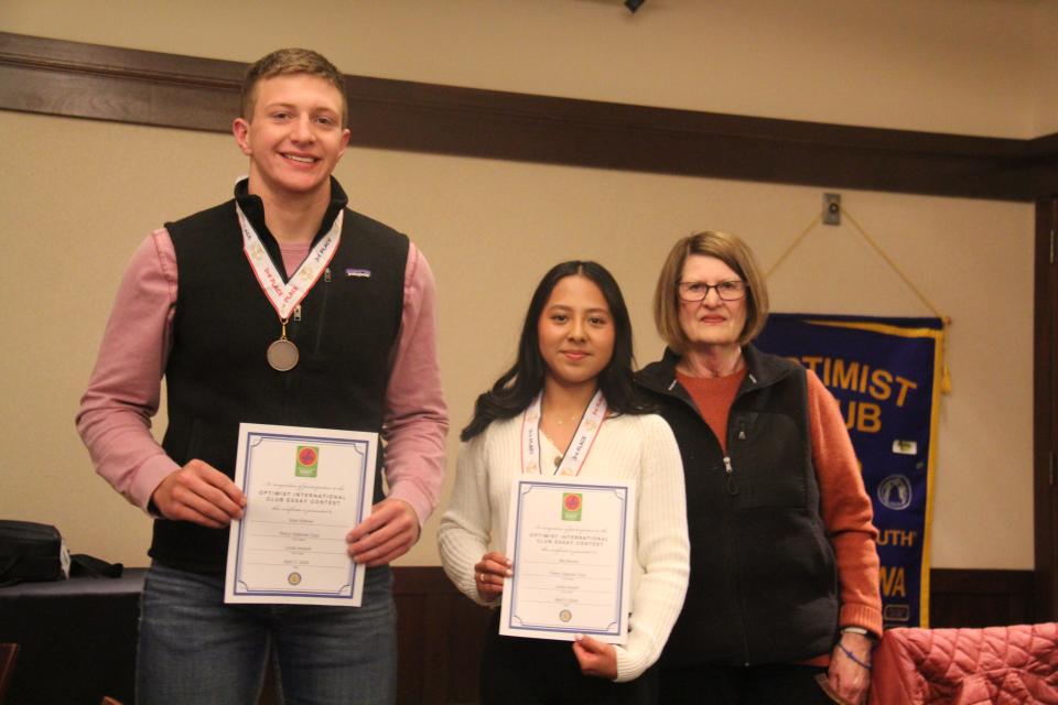 Linda Andorf poses for a photo with Kain Killmer and Mia Munoz, who tied for third place in the Perry Optimist Club essay contest.