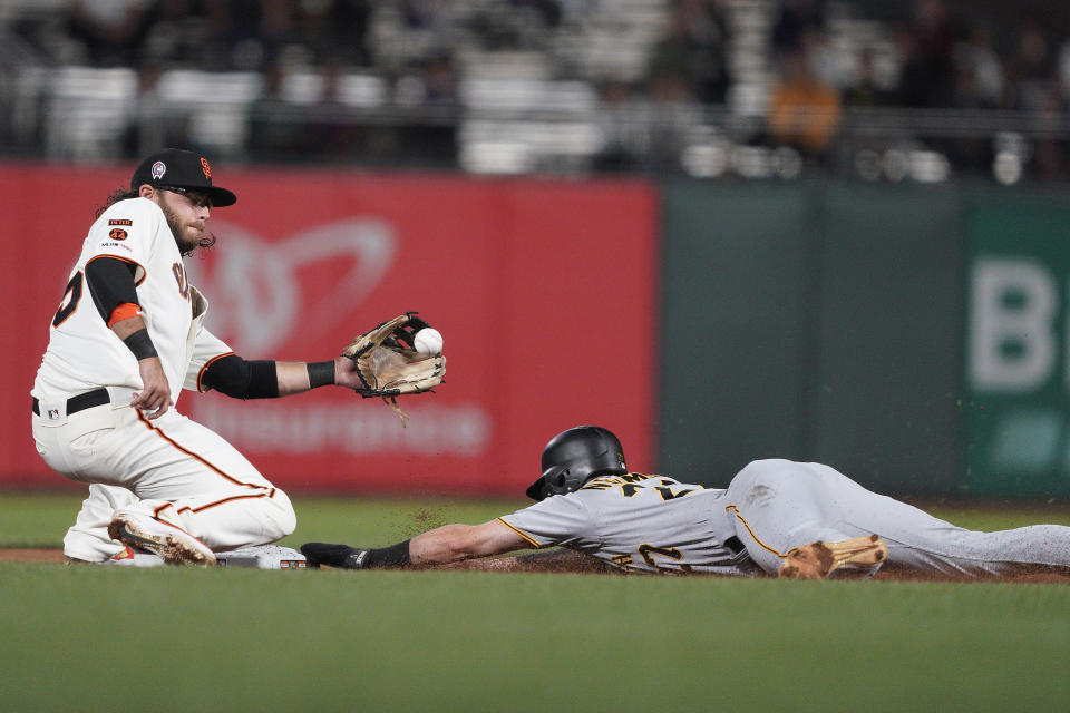 Pittsburgh Pirates' Kevin Newman, right, slides safely into second with a stolen base, next to San Francisco Giants shortstop Brandon Crawford during the fifth inning of a baseball game Wednesday, Sept. 11, 2019, in San Francisco. (AP Photo/Tony Avelar)