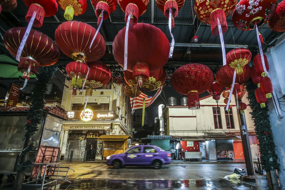 A taxi drives past a deserted Petaling Street duing the CMCO November 23, 2020. — Picture by Hari Anggara