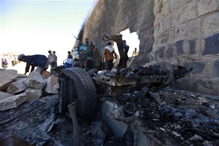 Workers rebuild the main prison wall after an explosion outside the central prison in Sanaa, in this February 14, 2014 file photo. REUTERS/Mohamed al-Sayaghi/Files