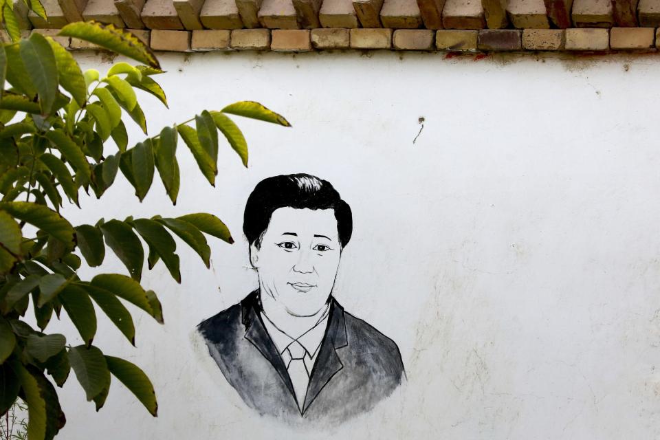 n this Sept. 20, 2018, photo, a drawing of China's President Xi Jinping is seen on the wall of a house in the Unity New Village in Hotan, in western China's Xinjiang region. While thousands of Uighur Muslims across China’s Xinjiang region are forced into re-education camps, China’s fledgling vision for ethnic unity is taking shape in a village where Han Chinese work and live alongside Uighur minorities. (AP Photo/Andy Wong)