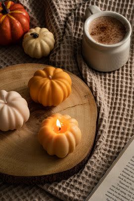 A pumpkin candle you can place on a little dish