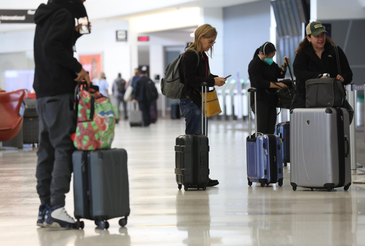 SAN FRANCISCO, CALIFORNIA - MAY 12: United Airlines customers prepare to check in for flights at San Francisco International Airport on May 12, 2022 in San Francisco, California. According to a report by the Bureau of Labor Statistics, airline fares surged 18.6% in April as demand for air travel has increased due to COVID-19-related travel restrictions being eased. (Photo by Justin Sullivan/Getty Images)