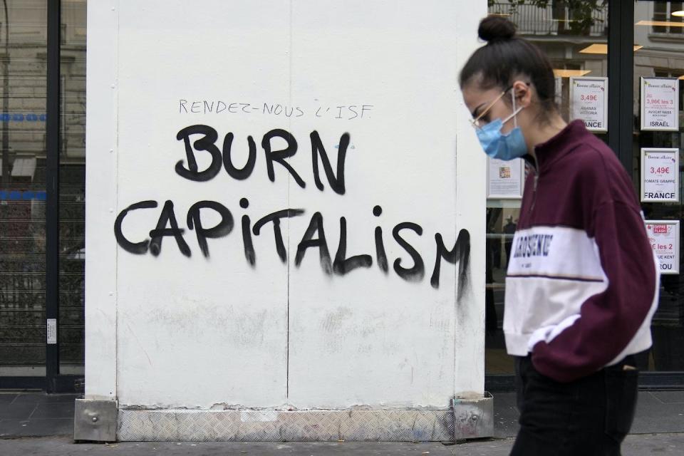 An environmental group takes part in a three-day demonstration against what they call France’s inaction on climate issues in Paris in April 2022. (AP Photo/Francois Mori)