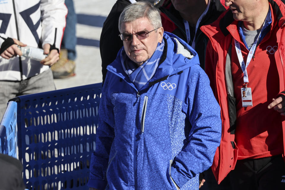 IOC (International Olympic Committee) president Thomas Bach walks in the finish area of the alpine ski, men's World Championship downhill, in Courchevel, France, Sunday, Feb. 12, 2023. (AP Photo/Marco Trovati)