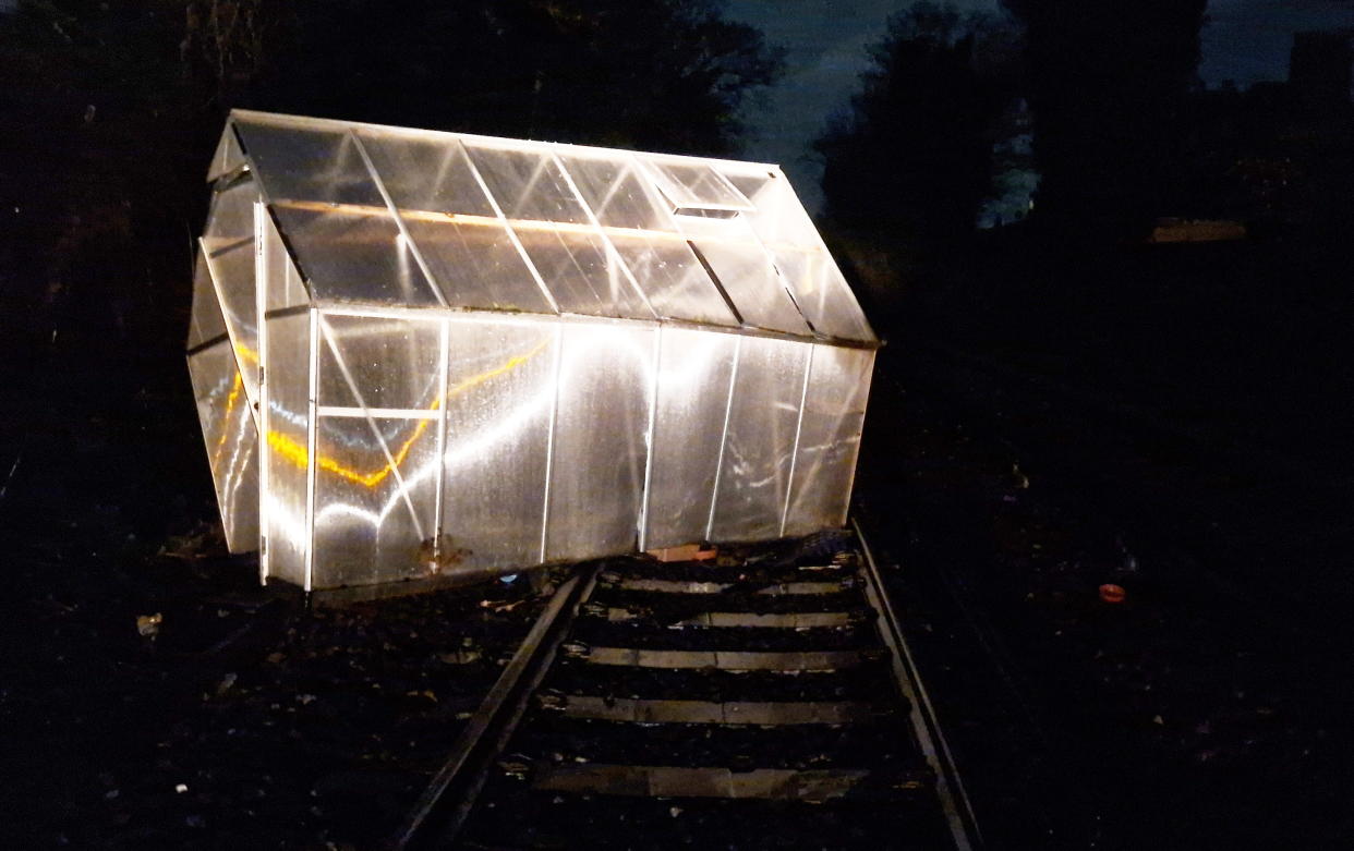 An entire greenhouse was blown onto train tracks by Storm Isha last night.  Release date – January 22, 2023.  See SWNS story SWLSisha.  With gusts of up to 80 mph, the storm battered Britain, closing roads, railways and ferries.  Just after midnight, Southeastern Railway posted this picture of a greenhouse blocking the tracks at Westgate-on-Sea, near Ramsgate in Kent. 
 