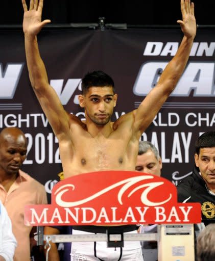 British boxer Amir Khan on the scales during the official weigh-in on July 13 in Las Vegas. Khan knows that another defeat after the Lamont Peterson loss would push unbeaten Danny Garcia ahead of him on many promoters' lists