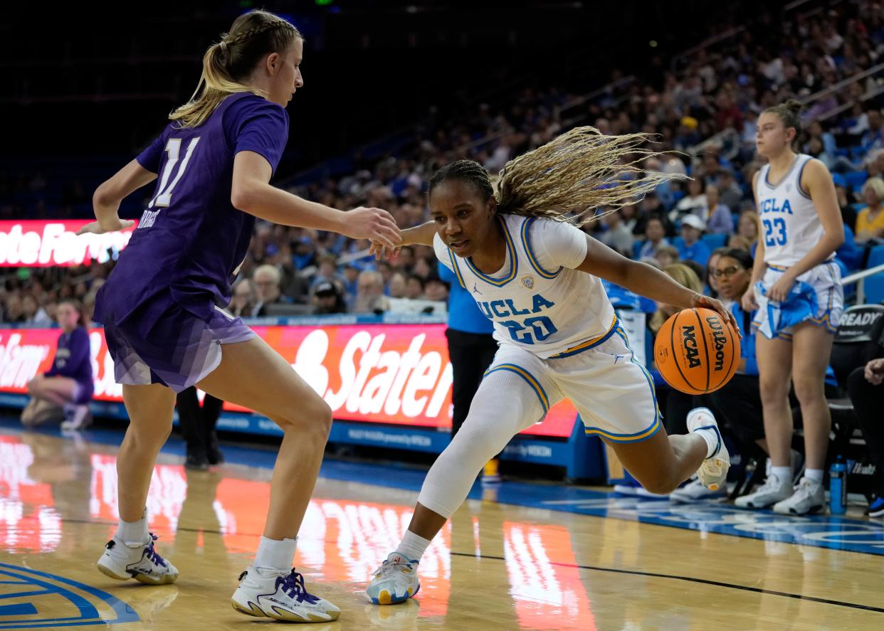 Washington guard Chloe Briggs (11) defends against UCLA guard Charisma Osborne (20) during the second half of the game in Los Angeles, Friday, Jan. 26, 2024.