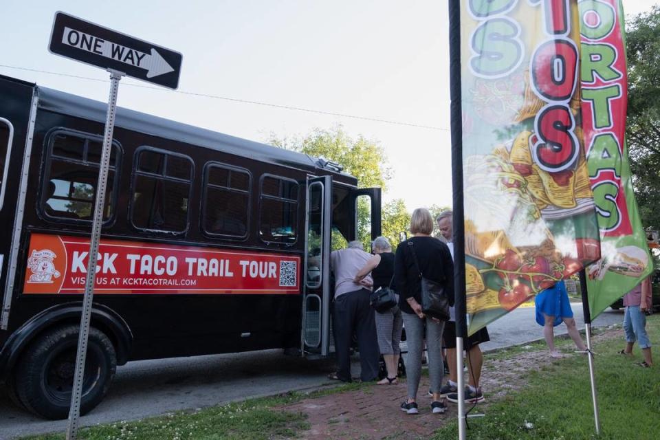 KCK Taco Trail Tour riders board the Red Machine Party Bus after visiting Tacos El Tio on Wednesday in Kansas City, Kansas.