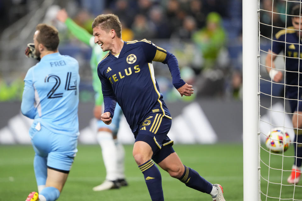 Vancouver Whitecaps midfielder Ryan Gauld reacts after scoring against Seattle Sounders goalkeeper Stefan Frei (24) during the second half of an MLS soccer match Saturday, April 20, 2024, in Seattle. (AP Photo/Lindsey Wasson)