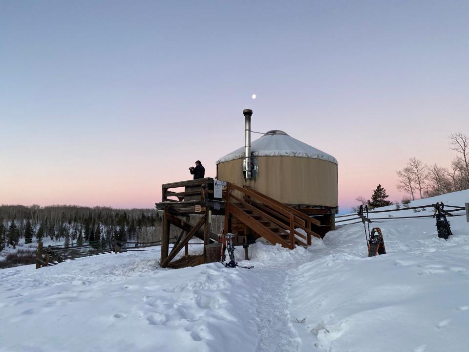 A visitor stands on the deck of a Never Summer Nordic yurt in Colorado State Forest State Park in this undated photo. Colorado Parks and Wildlife has terminated its contract with the company, leaving customers searching for refunds.