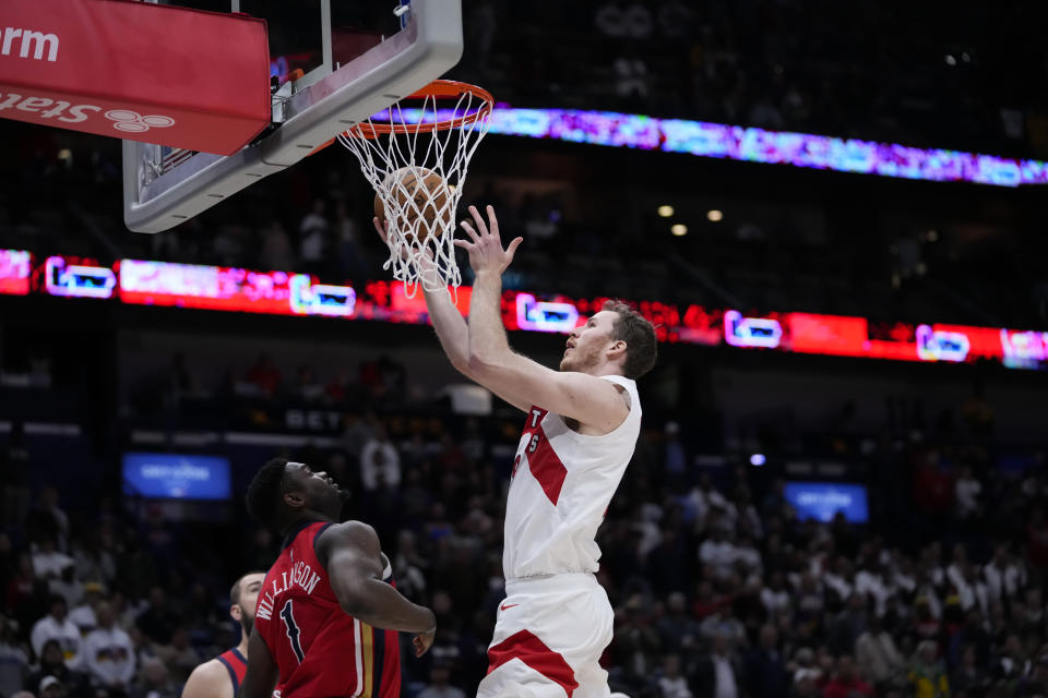 Toronto Raptors center Jakob Poeltl (19) goes to the basket over New Orleans Pelicans forward Zion Williamson (1) in the first half of an NBA basketball game in New Orleans, Monday, Feb. 5, 2024. (AP Photo/Gerald Herbert)