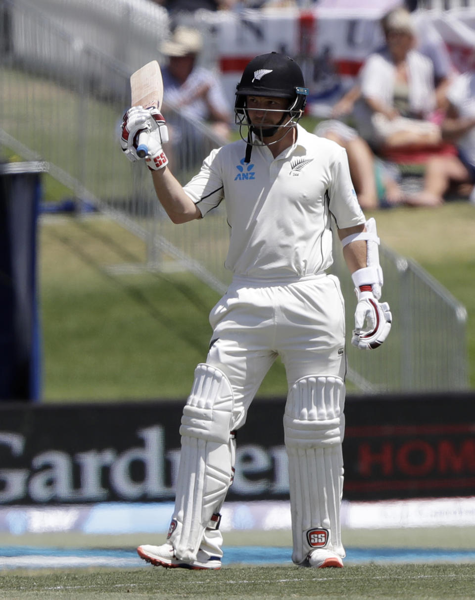 New Zealand's BJ Watling celebrates after reaching 50 runs during play on day three of the first cricket test between England and New Zealand at Bay Oval in Mount Maunganui, New Zealand, Saturday, Nov. 23, 2019. (AP Photo/Mark Baker)