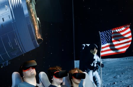 Visitors participate in an Apollo 11 virtual reality ride on the 50th anniversary of the moon landing at the Charles Simonyi Space Gallery at the Museum of Flight in Seattle