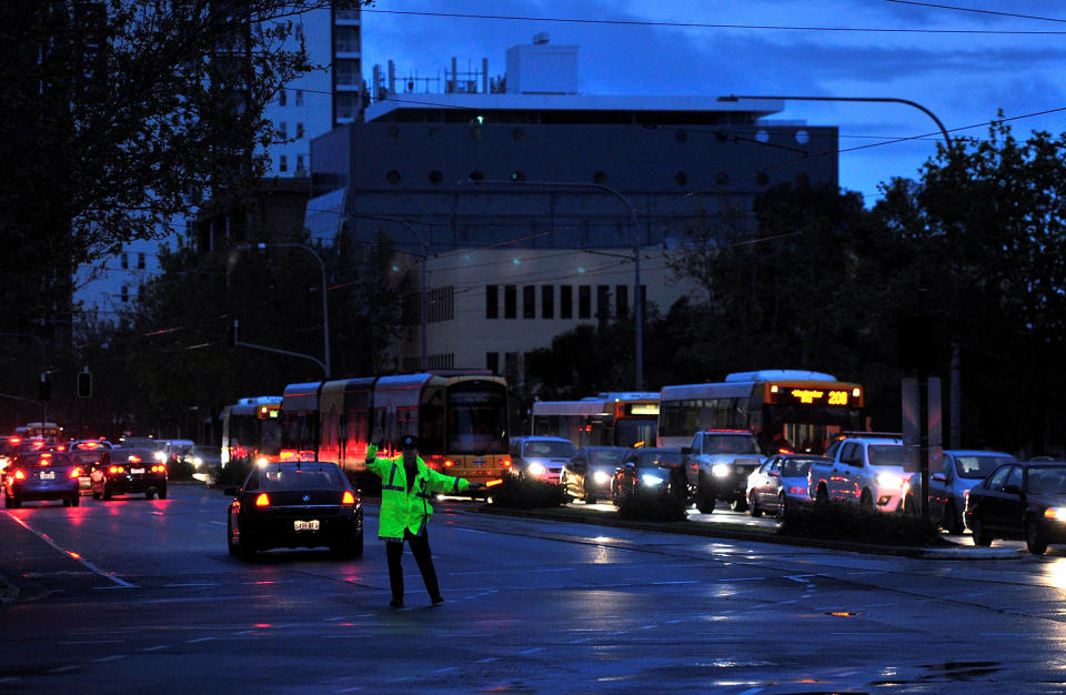 <p>Police direct traffic in the central business district (CBD) of Adelaide after severe storms and thousands of lightning strikes knocked out power to the entire state of South Australia, Sept. 28, 2016. (Photo: David Mariuz/Reuters) </p>