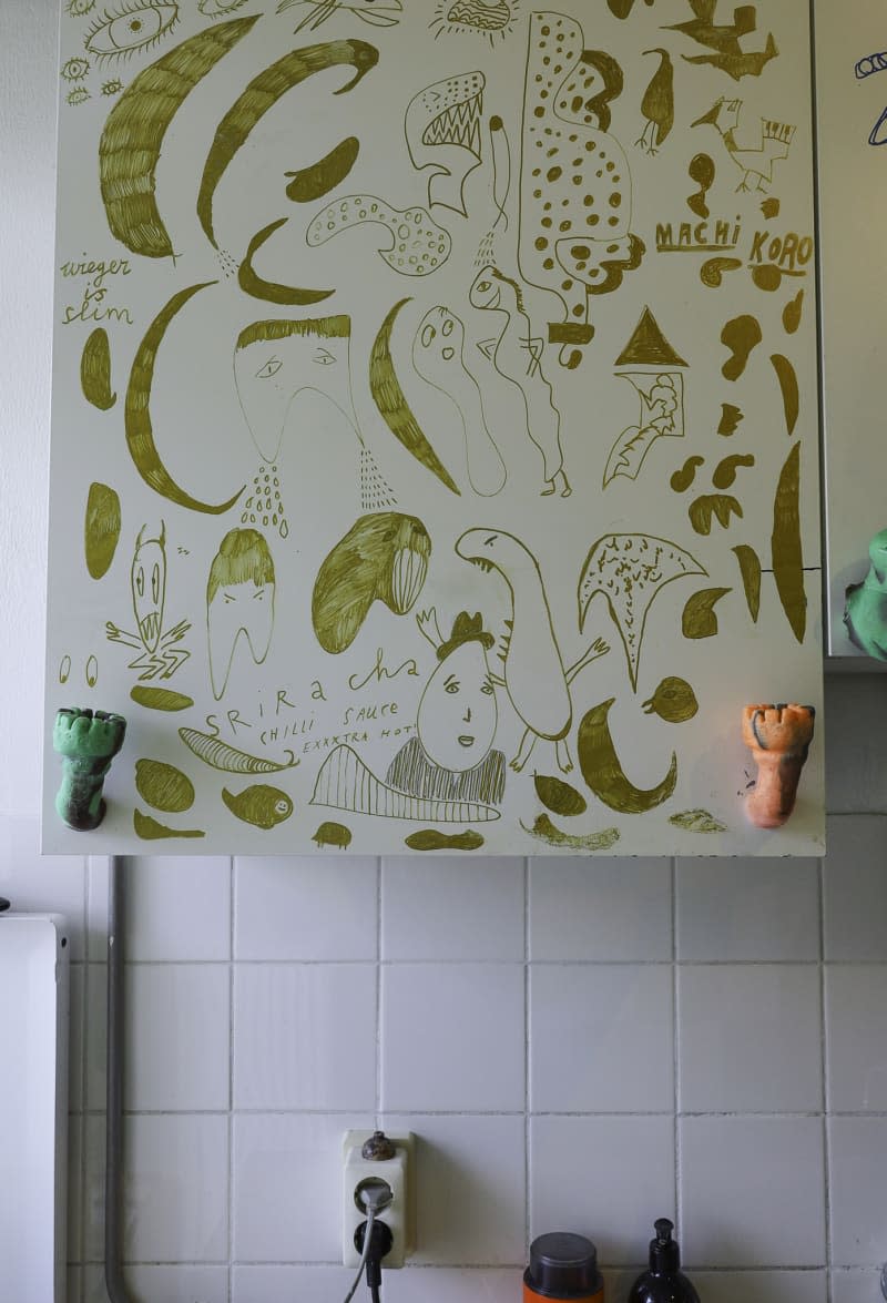 detail of artwork in white tiled kitchen