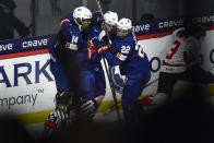 United States forward Hilary Knight, center, celebrates with forwards Laila Edwards, left, and Tessa Janecke after scoring against Canada during the third period in the final at the IIHF Women's World Hockey Championships in Utica, N.Y., Sunday, April 14, 2024. (AP Photo/Adrian Kraus)