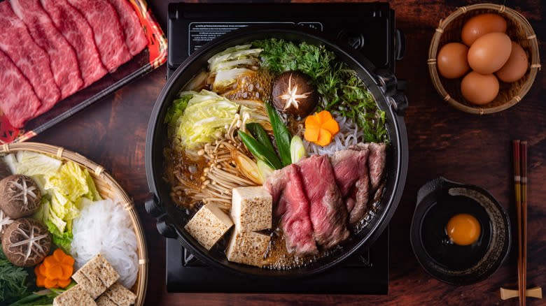 Sukiyaki cooking in pot with ingredients