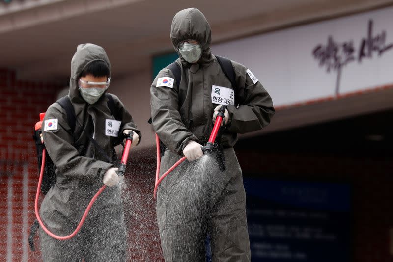 South Korean soldiers spray disinfectants inside an apartment complex which is under cohort isolation after mass infection of coronavirus disease (COVID-19) in Daegu