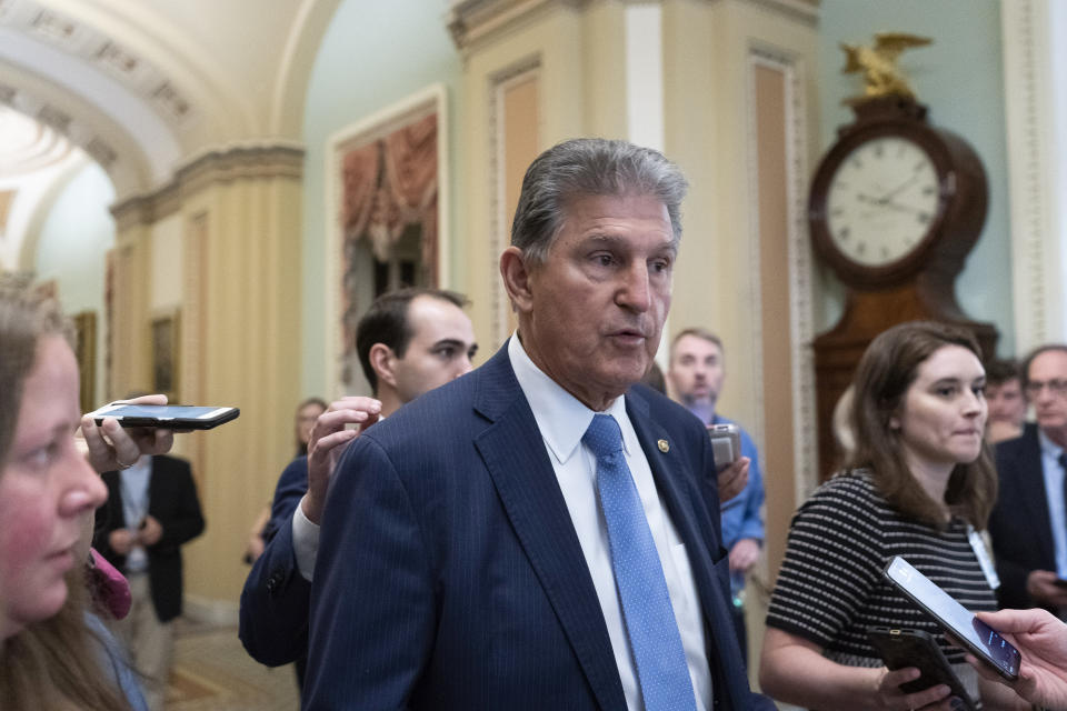 Sen. Joe Manchin, D-W.Va., speaks with reporters as he walks at the Capitol in Washington, Thursday, June 24, 2021. A bipartisan group of lawmakers have negotiated a plan to pay for an estimated $1 trillion compromise plan. (AP Photo/Alex Brandon)