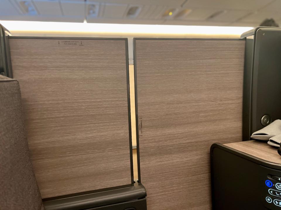 A seat on ANA's "The Room" business class seat with its privacy door closed.