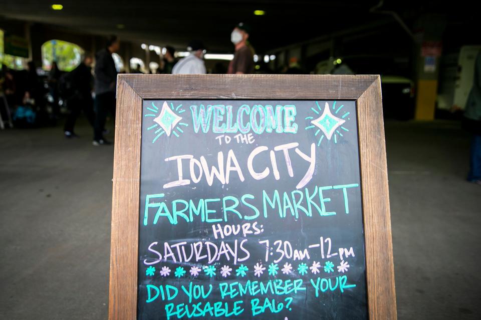 A sign welcomes people during the Iowa City Farmers Market, Saturday, May 6, 2023, at Chauncey Swan Ramp in Iowa City, Iowa.