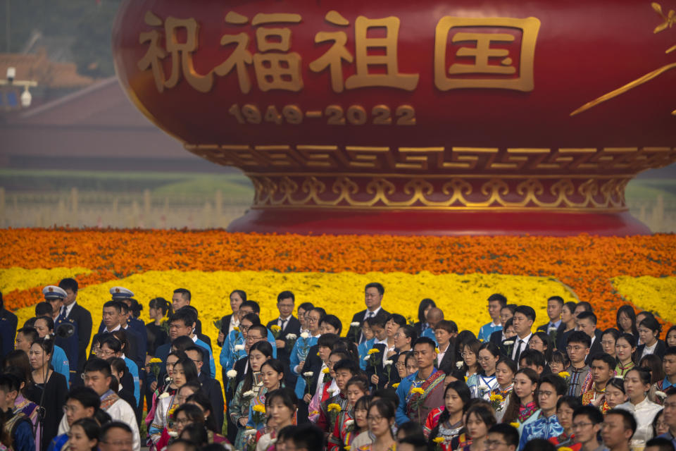 Participants stand before a ceremony to mark Martyr's Day at the Monument to the People's Heroes at Tiananmen Square in Beijing, Friday, Sept. 30, 2022. (AP Photo/Mark Schiefelbein)