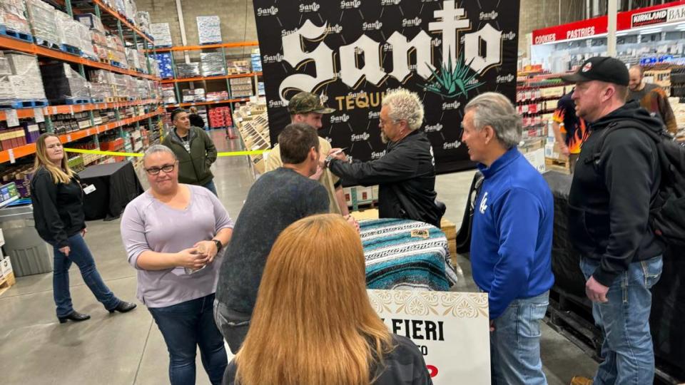 Celebrity Chef Guy Fieri signs tequila bottles at Costco in San Luis Obispo on March 6, 2024.