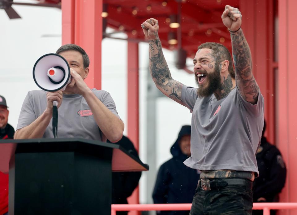 Raising Cane’s founder Todd Graves and Post Malone host a grand opening celebration of a Raising Cane’s Restaurant.