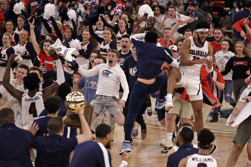 FILE - Robert Morris fans run onto the court as the team celebrates following a 77-67 win over St. Francis in an NCAA college basketball game for the Northeast Conference men's tournament championship in Pittsburgh, Tuesday, March 10, 2020. Recent incidents in college basketball have underscored the potential dangers that come from jubilant fans storming the court after the game comes to an end. Finding a solution is proving to be a challenge. (AP Photo/Gene J. Puskar, File)