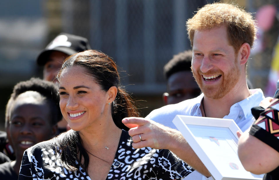 Prince Harry and his Meghan Markle smile during a stop on the first day of their African tour in Cape Town, South Africa, on Sept. 23. (Photo: Toby Melville/Reuters)