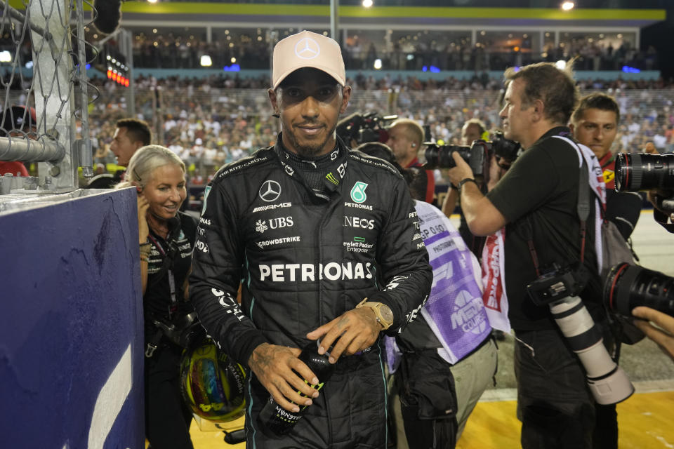 Mercedes driver Lewis Hamilton of Britain walks after clocking the third fastest time during the qualifying session at the Singapore Formula One Grand Prix, at the Marina Bay City Circuit in Singapore, Saturday, Oct. 1, 2022. (AP Photo/Vincent Thian)