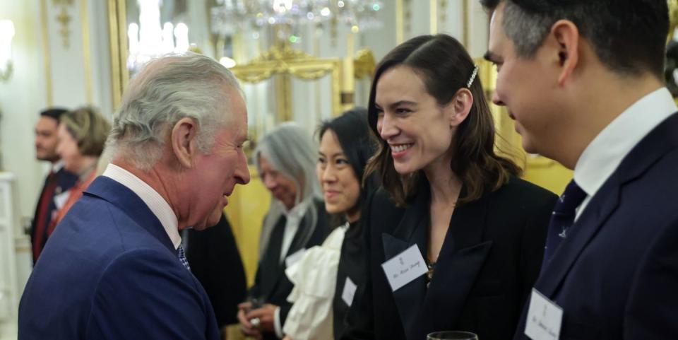 london, england february 01 king charles iii meets with alexa chung and dominic chung during a reception hosted by the king and the queen consort to celebrate british east and south east asian communities at buckingham palace on february 01, 2023 in london, england the reception is taking place shortly after lunar new year, the holiday began as a time for feasting and to honour household and heavenly deities, as well as ancestors guests include representatives of the armed forces, the arts, media, fashion, business, government, finance, healthcare, faith organisations and charities photo by chris jackson wpa poolgetty images